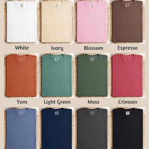 The image is a color chart displaying various comfort colors, including white, ivory, blossom, espresso, yam, light green, moss, Crimson, blue jeans, true navy, pepper, and black.