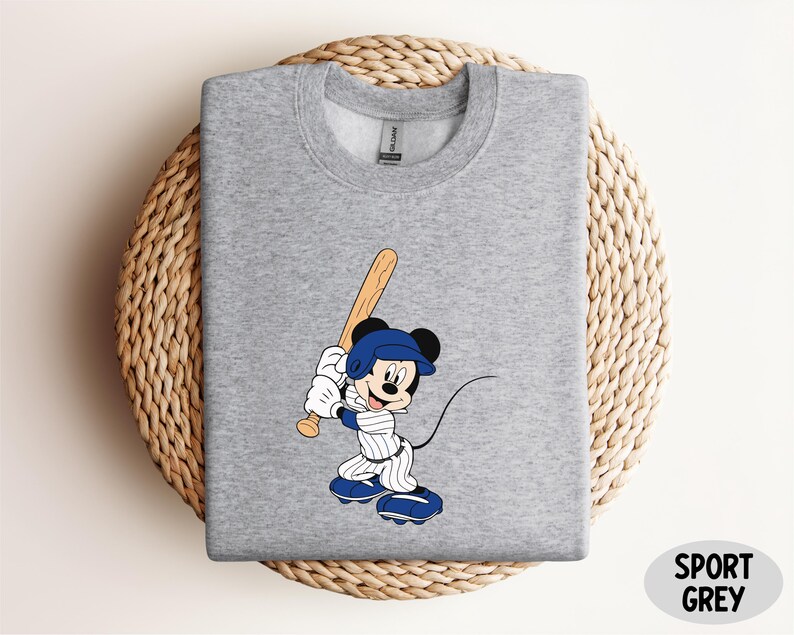 a mickey mouse t - shirt with a baseball bat on it
