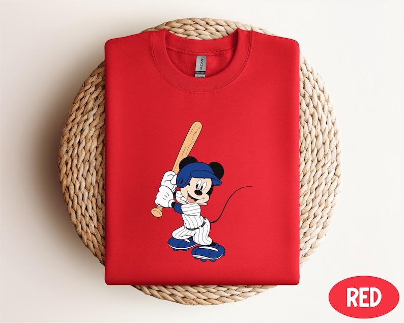 a red shirt with a mickey mouse holding a baseball bat