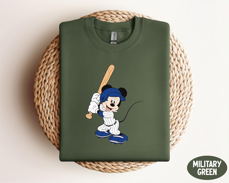 a mickey mouse t - shirt with a baseball bat on it