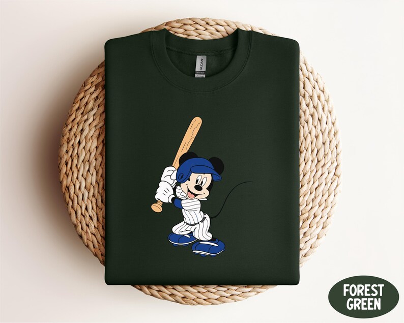a green shirt with a mickey mouse holding a baseball bat