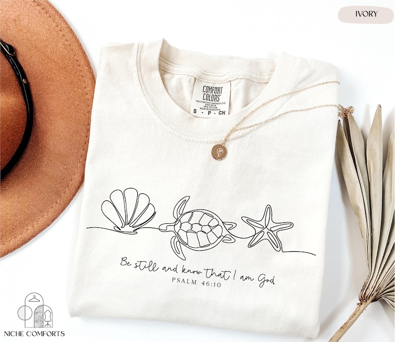 a hat, sunglasses, and t - shirt on a table