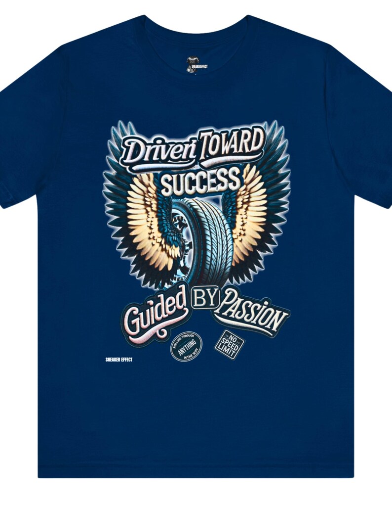 May include: A navy blue t-shirt with a graphic of a tire with wings and the text "Driven Toward Success Guided By Passion". The graphic also includes two smaller circles with the text "Rolling Through Anything In The Way" and "No Speed Limit".