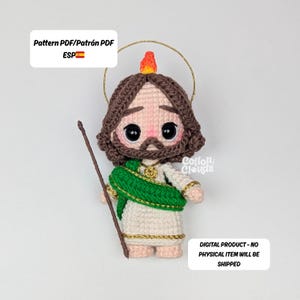 May include: A crocheted doll of a saint, featuring a brown beard and hair, a green sash, and a gold halo. The doll is holding a wooden staff. The text "Pattern PDF/Patrón PDF ESP" and "DIGITAL PRODUCT - NO PHYSICAL ITEM WILL BE SHIPPED" are visible.