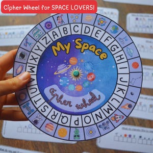May include: A colorful cipher wheel with a space theme, featuring planets, stars, and a rocket ship. The wheel has the text "My Space" and "cipher wheel". The top of the wheel reads "Cipher Wheel for SPACE LOVERS!"