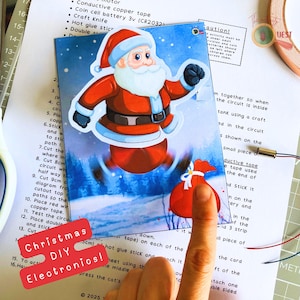 May include: A Christmas DIY electronics project featuring a Santa Claus illustration with a red sack of gifts. The image includes instructions and the text "Christmas DIY Electronics!"