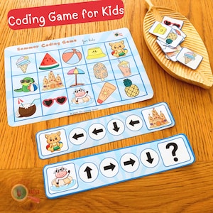 May include: A children's coding game with a summer theme. The game features a grid with summer icons, arrow-marked instruction cards, and small picture cards. The text "Coding Game for Kids" is at the top. The game is on a wooden surface.