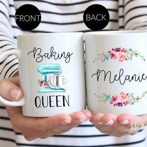 May include: White ceramic mug with a blue and white mixer illustration and the text "Baking Queen". The back of the mug has a floral design and the name "Melanie".