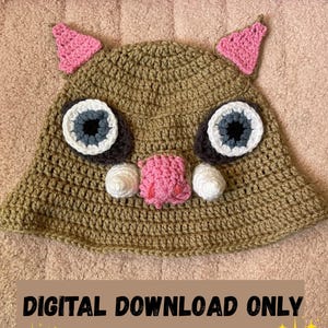 May include: Crocheted hat in a tan color, featuring large, round eyes with white, gray, and black details. Pink triangles form the ears, and a pink snout with white tusks are also present. The text "DIGITAL DOWNLOAD ONLY" is displayed on the bottom.