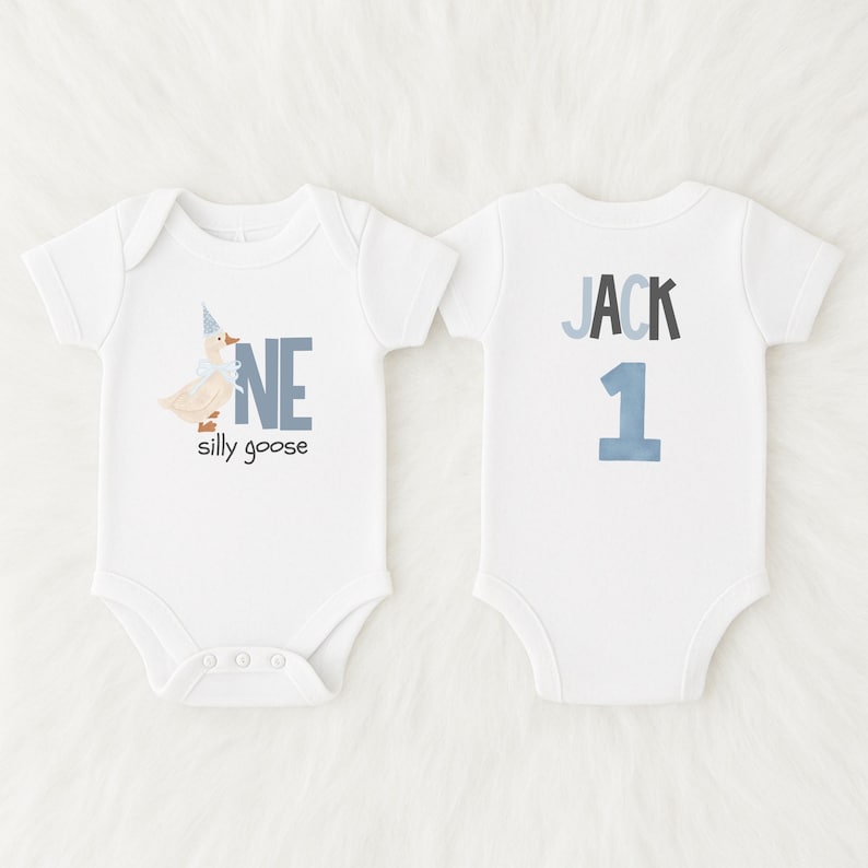 May include: Two white baby onesies. One has a goose graphic with the text "NE silly goose". The other has the name "JACK" and the number "1". The text and graphics are in shades of blue and gray.