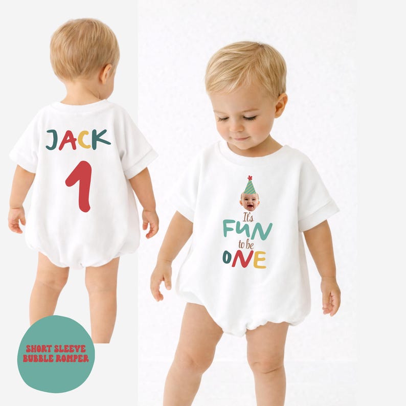 May include: White short-sleeve bubble romper with the text "It's FUN to be ONE" and a baby wearing a party hat. The back of the romper has the name "JACK" and the number "1". The romper is designed for a baby's first birthday.