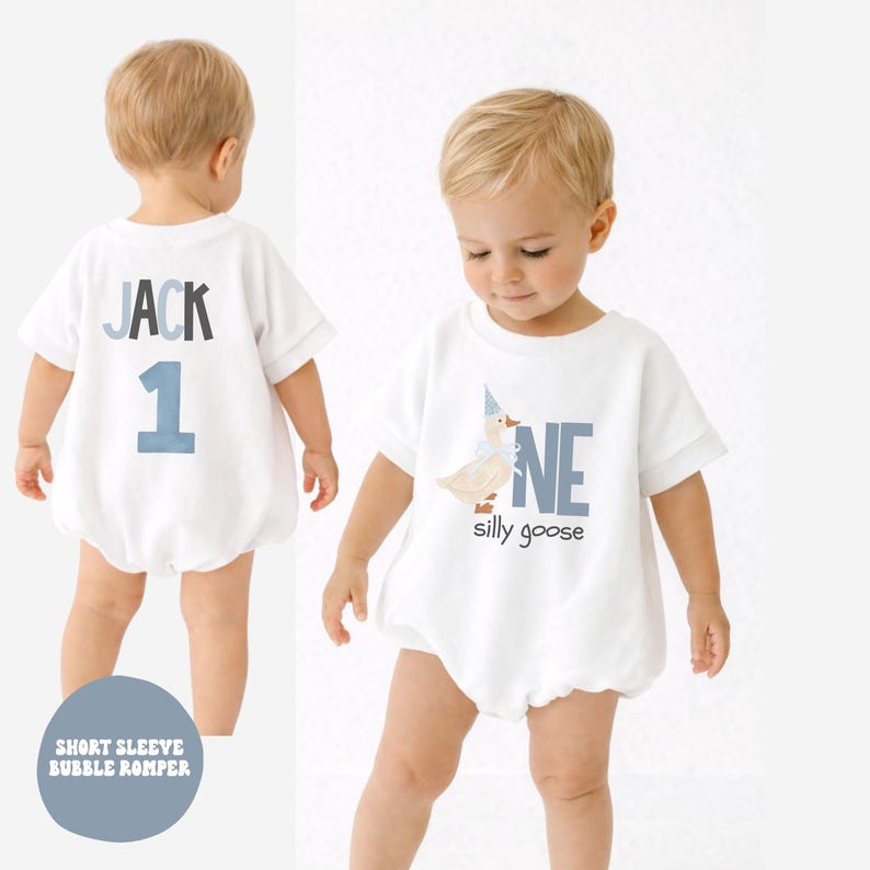 May include: White short-sleeve bubble romper with the text "JACK" and the number "1" in blue on the back. The front of the romper features the text "ONE" and a goose illustration with the words "silly goose".