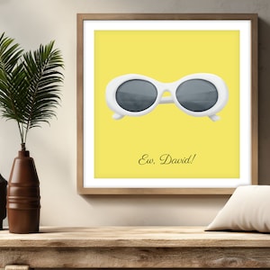 May include: A yellow square print with a white pair of round sunglasses and the text "Ew, David!" in black.