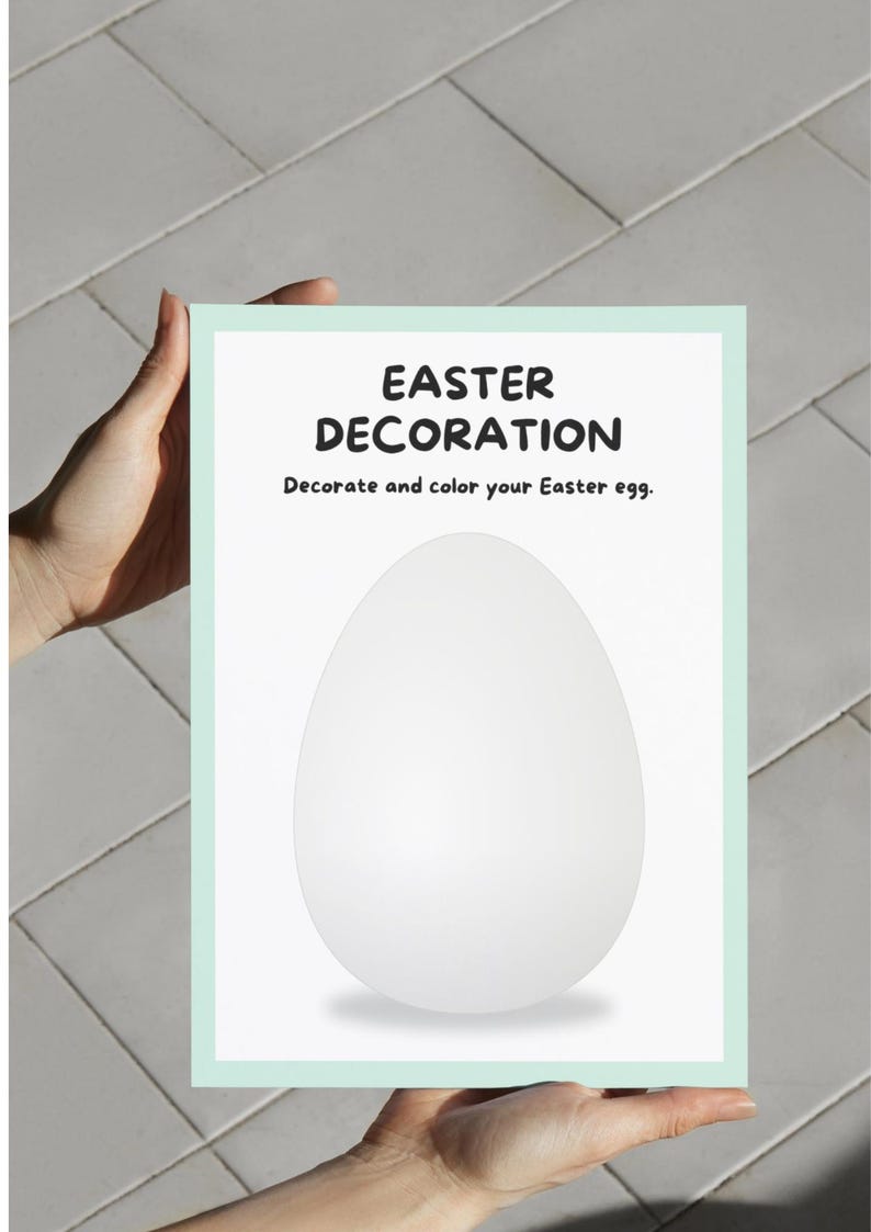 May include: A rectangular sign with a light green border and the words "EASTER DECORATION" in bold black letters. Below the title is the text "Decorate and color your Easter egg." A large white egg shape is in the center of the sign.
