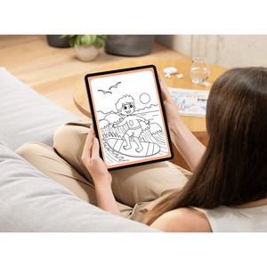 May include: A person is holding a tablet with a black and white drawing of a person surfing on a wave. The drawing is on a white background with a peach colored border.