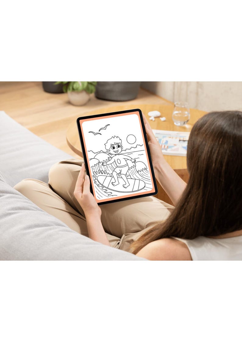 May include: A person is holding a tablet with a black and white drawing of a person surfing on a wave. The drawing is on a white background with a peach colored border.