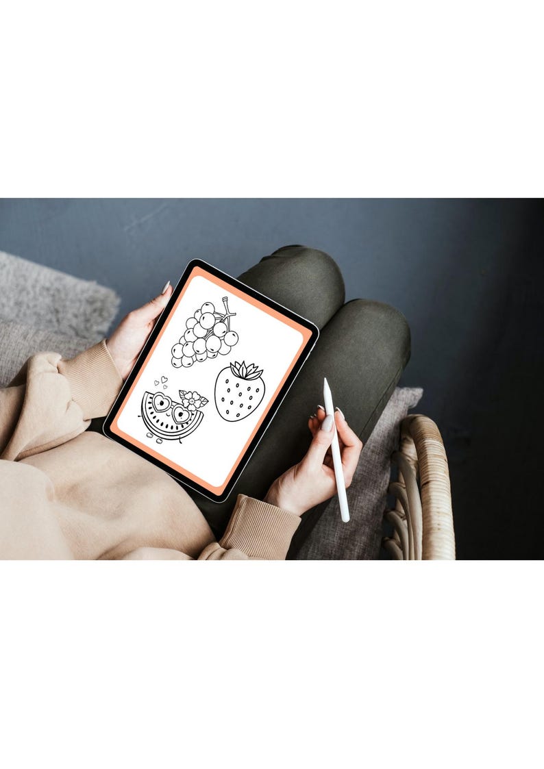 May include: A digital tablet with a white background and black line drawings of a watermelon, grapes, and a strawberry. The tablet is being held by a person's hands, and a white stylus is being held in the right hand.