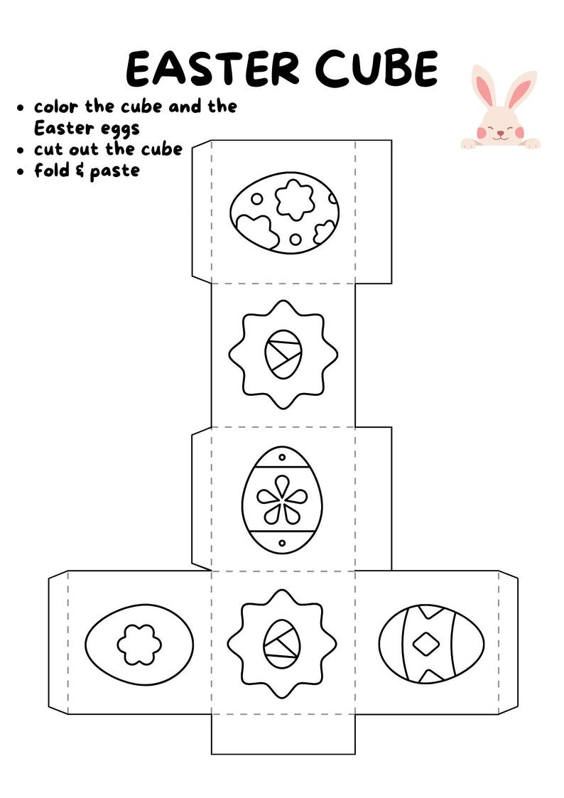 May include: A black and white Easter Cube template with instructions to color, cut, and assemble. The design features Easter eggs with various patterns and a small bunny illustration. The text reads "EASTER CUBE".