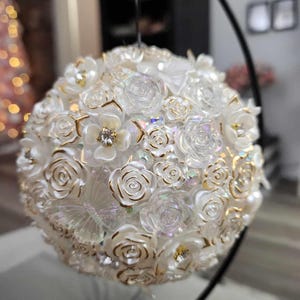 Ivory, gold with rhinestones home decor beaded orb. Approximately 5 inches diameter which varies slightly. Stand not included.