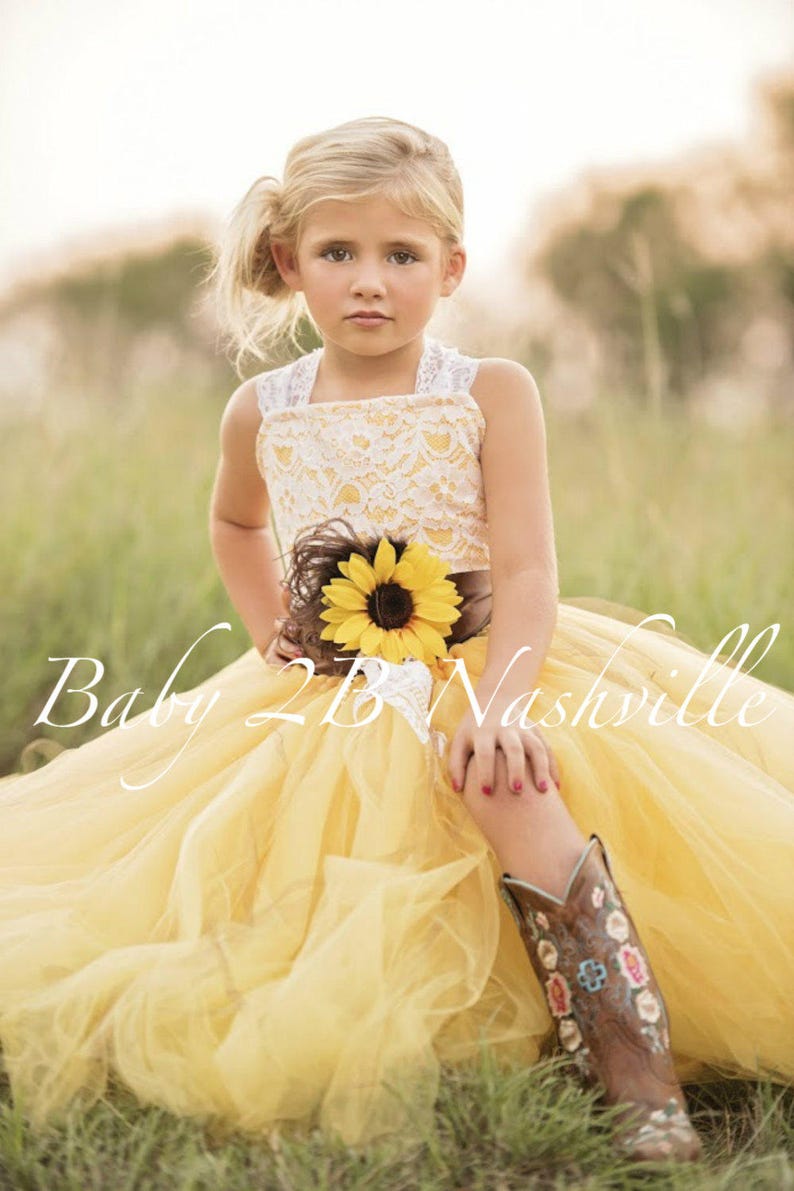 Wedding flower girl dress in yellow sunflower tulle with lace overlay bodice.