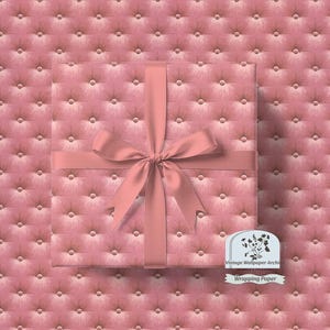 May include: A square gift box wrapped in pink paper with a tufted pattern and a matching ribbon tied in a bow. The background is a continuation of the pink tufted pattern. The image includes a label that says "Wrapping Paper".