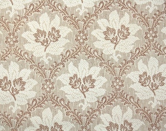 May include: Close-up of a fabric with a repeating floral pattern. The flowers are white with brown centers and are set against a beige background. The design is detailed and textured.