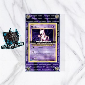 May include: A graded Mewtwo Pokémon card encased in a clear acrylic holder. The card features a purple and white design with the text "Mewtwo" and "130 HP." The holder is labeled with "Dragon Slabs" and includes the text "Card Not Included."