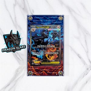 May include: A custom TCG case by Dragon Slabs, featuring a Mega Charizard X card. The card is encased in a clear, protective holder with a blue border. The case has the text "Dragon Slabs" repeated around the edges.