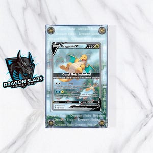 May include: A Dragonite V trading card in a clear protective case. The card features a yellow dragon with blue wings and the text "Dragonite V". The case has the text "Dragon Slabs" around the edges.