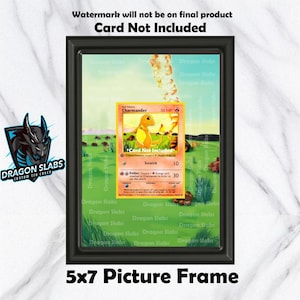 May include: A black 5x7 picture frame displaying a Pokémon Charmander card. The card is yellow and orange, with the text "Card Not Included". The frame is labeled "Dragon Slabs" and "Custom TCG Cases". The text "Watermark will not be on final product" is also visible.
