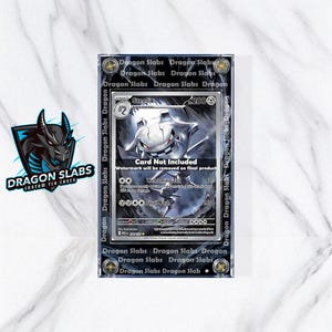 May include: A clear protective case for a trading card, featuring the text "Dragon Slabs" and a stylized dragon logo. The card inside is a Steelix Pokémon card. The case has a black border with the words "Dragon Slabs" repeated.