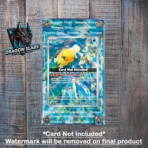 May include: A blue and white Pokemon card featuring a yellow and white character called "Kasumi no Kotack" with the number 70. The card is in a protective plastic case with the text "Dragon Slabs" printed on the case.