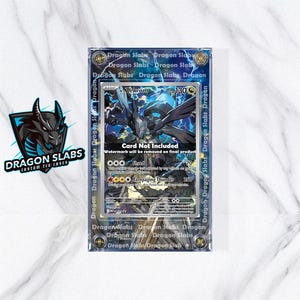May include: A Zekrom Pokémon card in a clear protective case. The card shows a black and blue illustration of Zekrom with ability and stat details. The case is branded with "Dragon Slabs".