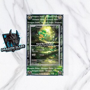 May include: A clear protective case for a trading card, featuring a green and yellow cartoon character. The card is labeled "Pansage" with a 700 value. The case is labeled "Dragon Slabs" and "Card Not Included".