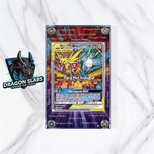 May include: A custom TCG case by Dragon Slabs. The case features a stained-glass style design with a Pokemon card inside. The card features Zapdos, Articuno, and Moltres. The case is rectangular with a purple border and the text "Dragon Slabs" around the edges.