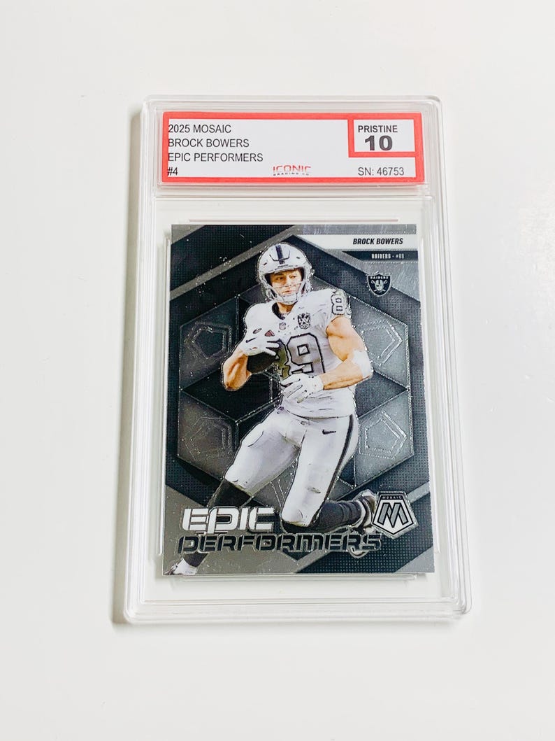 以下が含まれることがあります： アメフトのユニフォームを着たブロック・バウワーズをフィーチャーしたグレーディングされたトレーディングカード。カードは2025 Mosaic Epic Performersシリーズのもので、Pristine 10と評価されています。カードはモザイクデザインで、「EPIC PERFORMERS」の文字が入っています。