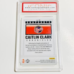 May include: A graded Caitlin Clark trading card in a clear plastic case. The card displays "SNAPSHOTS" and "CAITLIN CLARK CHRONICLED" with the Indiana Fever logo. The grading company's logo and website are visible at the top of the case.