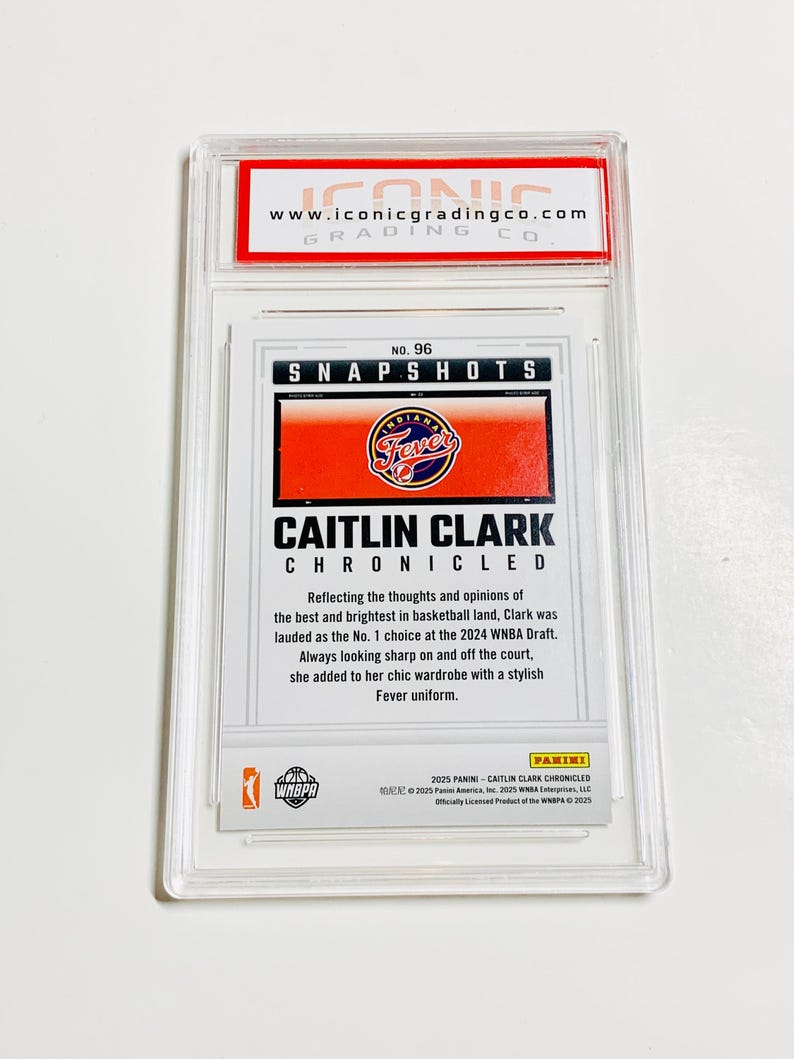 May include: A graded Caitlin Clark trading card in a clear plastic case. The card displays "SNAPSHOTS" and "CAITLIN CLARK CHRONICLED" with the Indiana Fever logo. The grading company's logo and website are visible at the top of the case.
