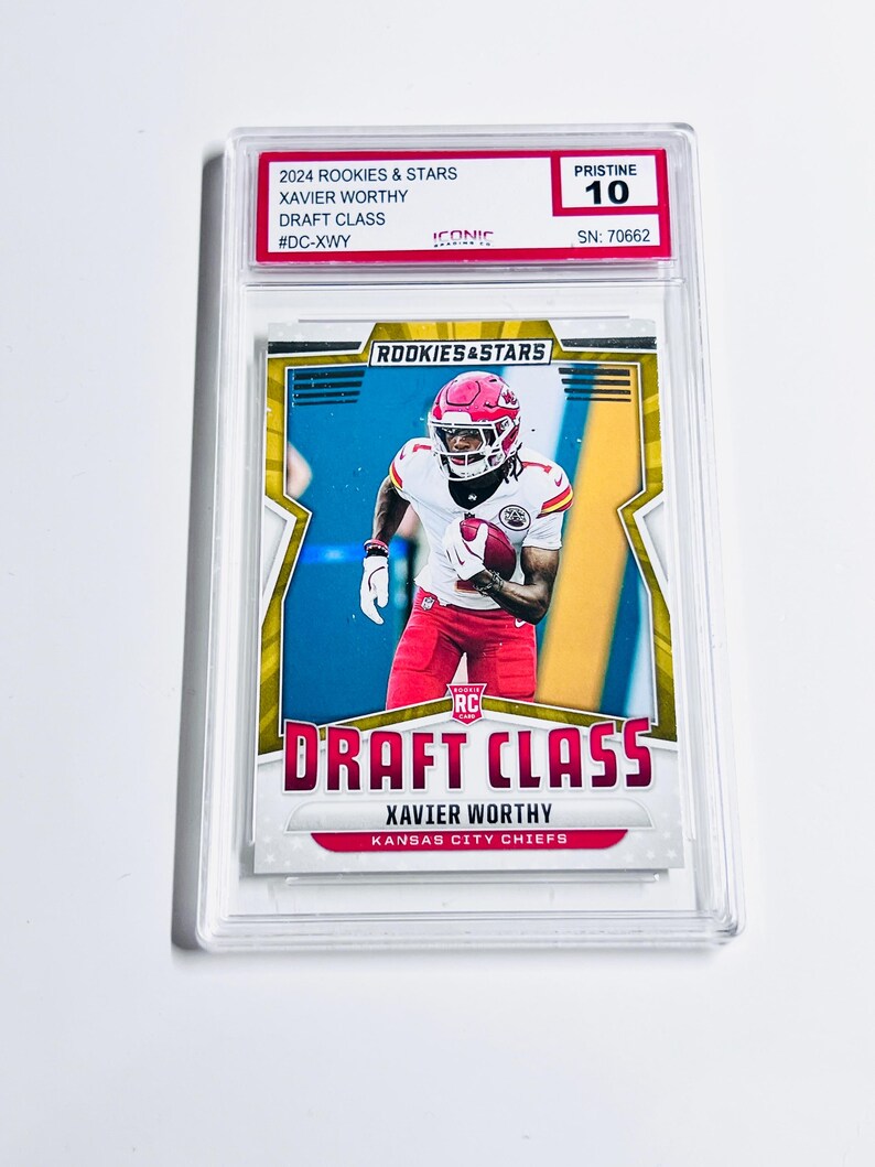 May include: A sports trading card featuring Xavier Worthy in a Kansas City Chiefs uniform. The card is labeled "2024 Rookies & Stars Draft Class" and is graded "Pristine 10". The card is encased in a clear protective holder.