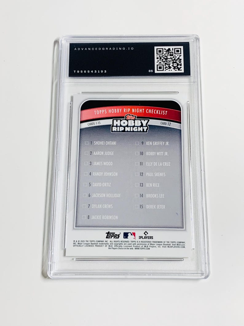 May include: A baseball card encased in a clear plastic holder. The card features a checklist of players, including Shohei Ohtani and Aaron Judge, with the text "TOPPS HOBBY RIP NIGHT CHECKLIST". The holder has a label from Advanced Grading.