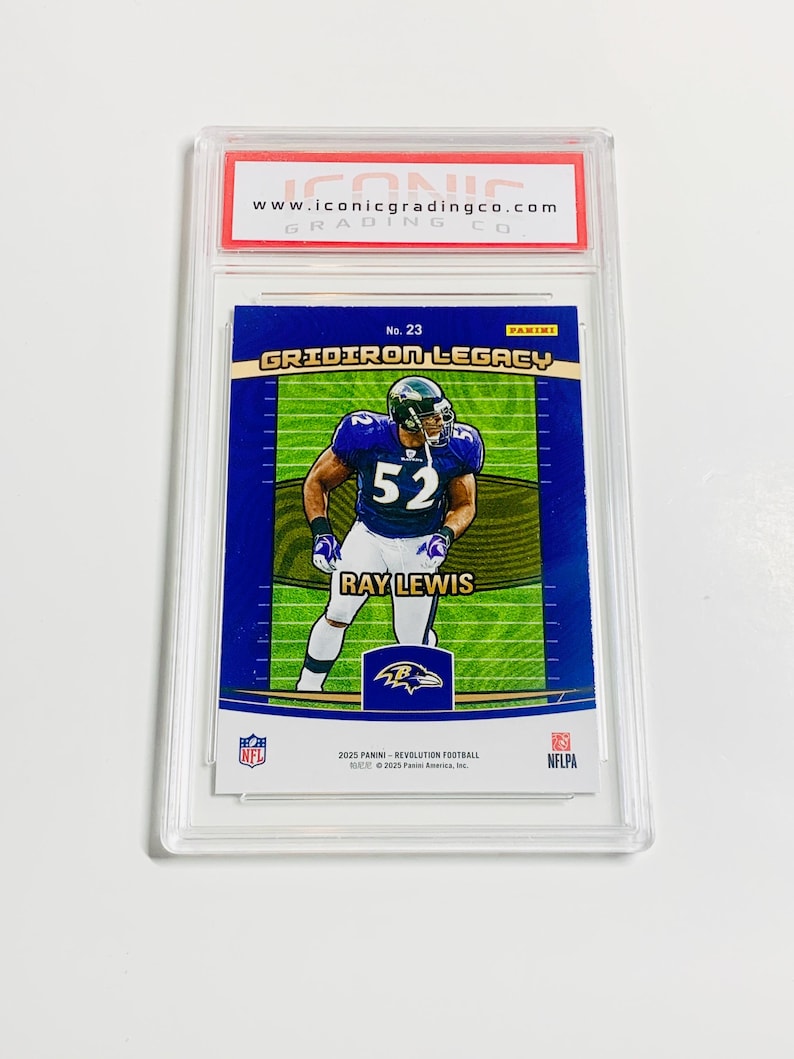 May include: A Ray Lewis football trading card, graded and encased in a protective holder. The card features a player in a purple and black uniform with the number 52. The card is labeled "Gridiron Legacy" and includes the NFL and Panini logos.