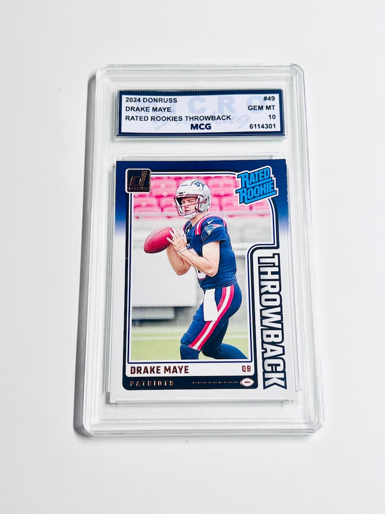 May include: A Drake Maye football trading card from the 2024 Donruss set, graded GEM MT 10. The card features a player in a Patriots uniform, labeled "Rated Rookie" and "Throwback."