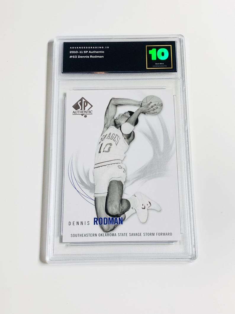 May include: A graded sports trading card featuring Dennis Rodman in action. The card is encased in a clear plastic holder and has a grade of 10. The card is from the 2010-11 SP Authentic series and features the text "SP Authentic".