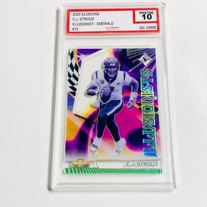 May include: A trading card featuring C.J. Stroud from the 2023 Illusions set, graded Pristine 10. The card has a vibrant design with the text "ILLUSIONISTS" and "C.J. STROUD". The card is encased in a protective holder.