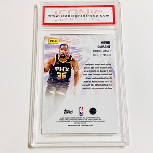 May include: A Kevin Durant Phoenix Suns trading card, graded by Iconic Grading Co. The card features a photo of Durant in his Suns uniform, with the team logo and his number 35. The card is encased in a clear protective holder.