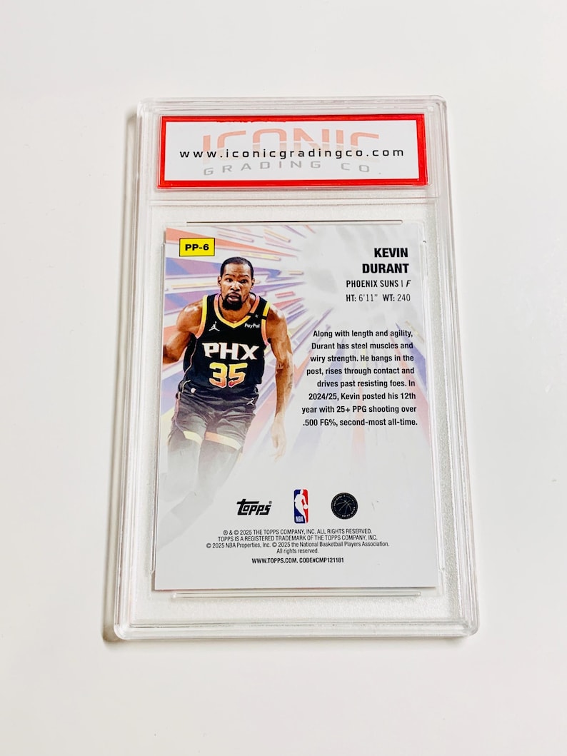 May include: A Kevin Durant Phoenix Suns trading card, graded by Iconic Grading Co. The card features a photo of Durant in his Suns uniform, with the team logo and his number 35. The card is encased in a clear protective holder.