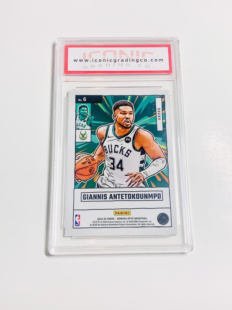 May include: A basketball trading card featuring Giannis Antetokounmpo in a Bucks uniform, number 34. The card is encased in a clear plastic holder with a red and white label from Iconic Grading Co. The card has a green and white background.