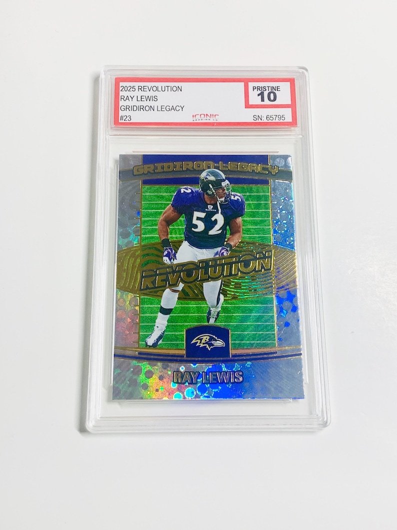May include: A Ray Lewis football trading card from the 2025 Revolution series, graded Pristine 10. The card features a player in a purple and white uniform. The card is encased in a clear protective holder.