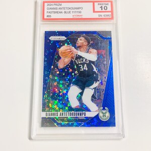 May include: A blue basketball card featuring Giannis Antetokounmpo in a Milwaukee Bucks uniform, holding a basketball. The card is graded Pristine 10 and is labeled as a 2024 Prizm Fastbreak Blue card.