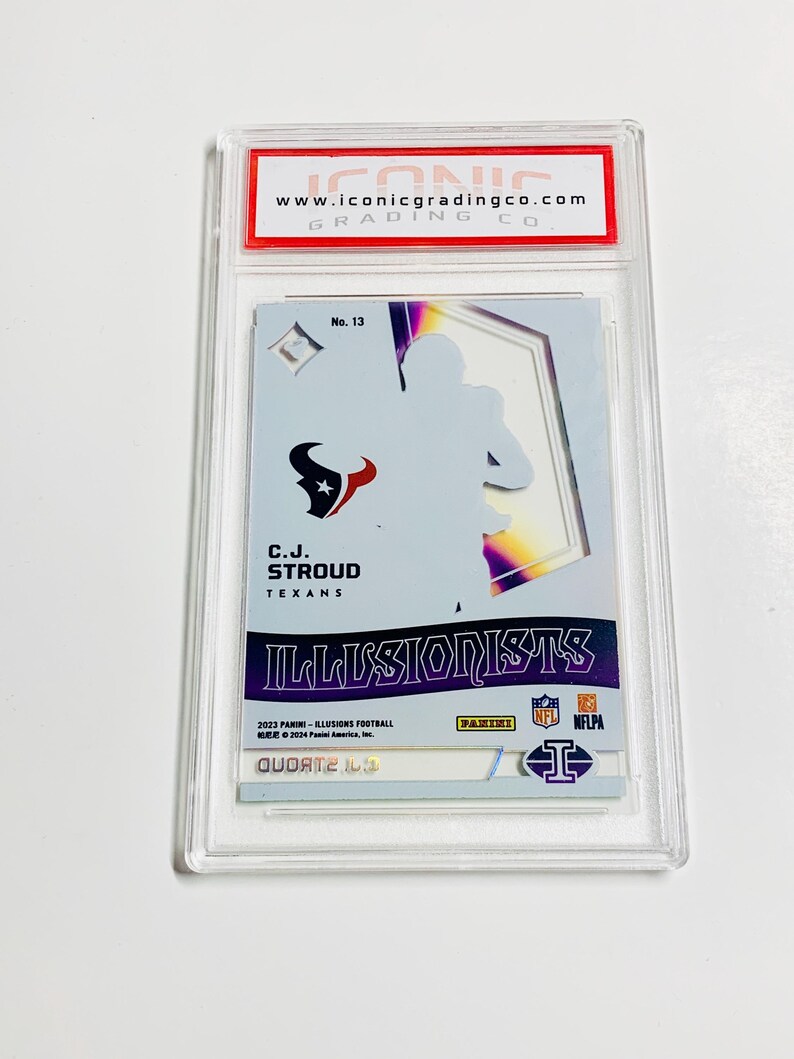 May include: A graded C.J. Stroud football card from the 2023 Panini Illusions series, encased in a protective holder. The card features the Texans logo and the text "ILLUSIONISTS". The grading company's website is visible at the top.
